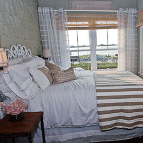 A white-themed bed room with furniture